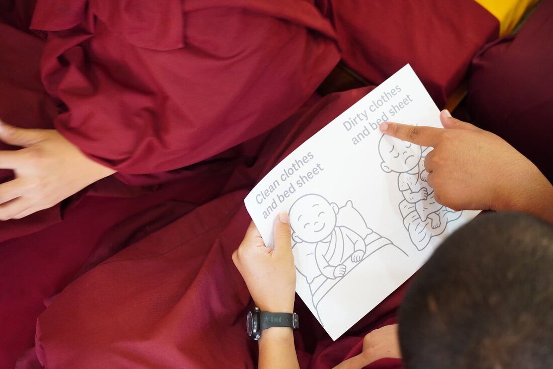 A close-up of an illustrated handout comparing clean and dirty clothes and bedding during a lesson.