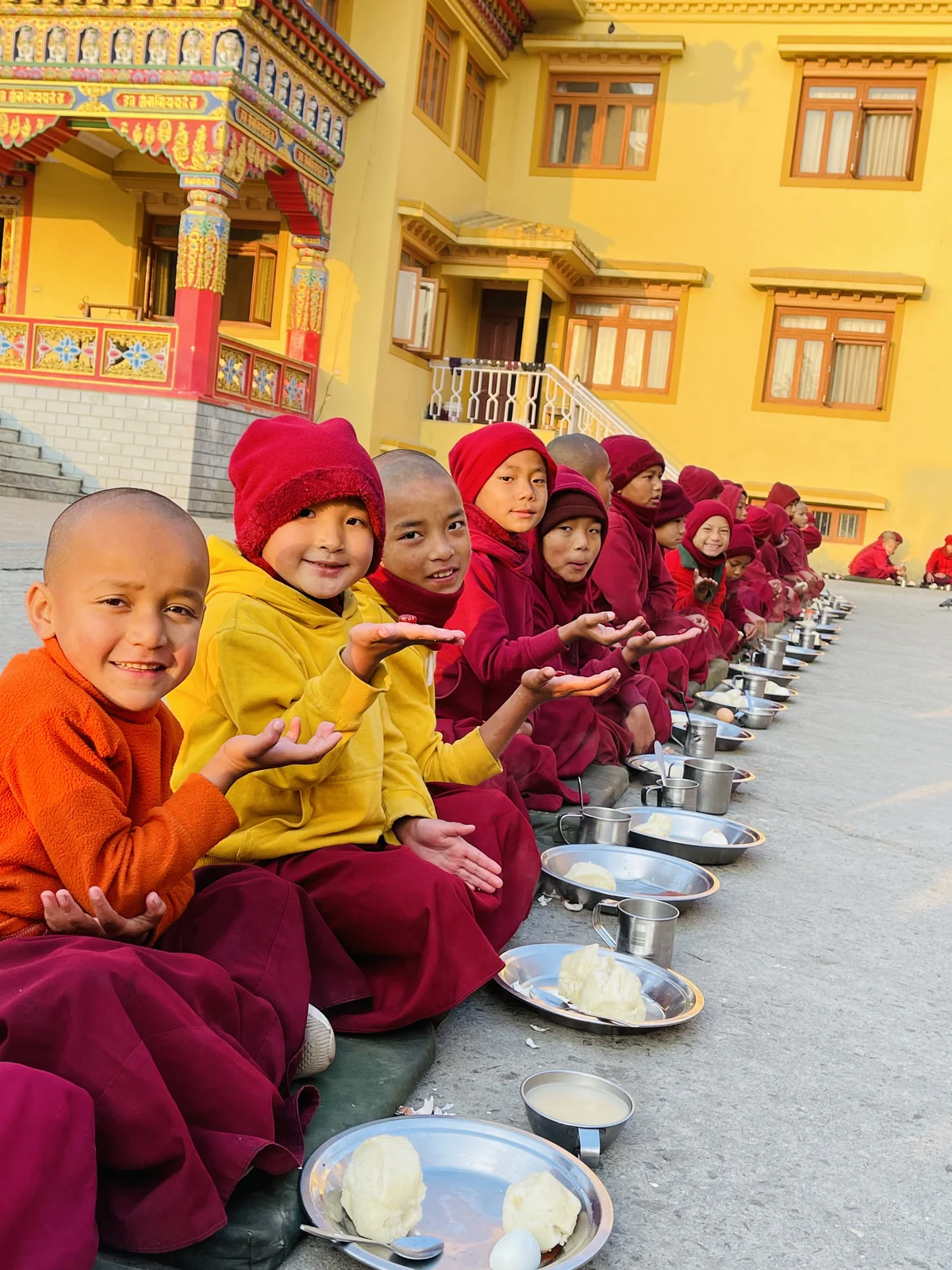 Children holding the vitamin gummies we distributed.